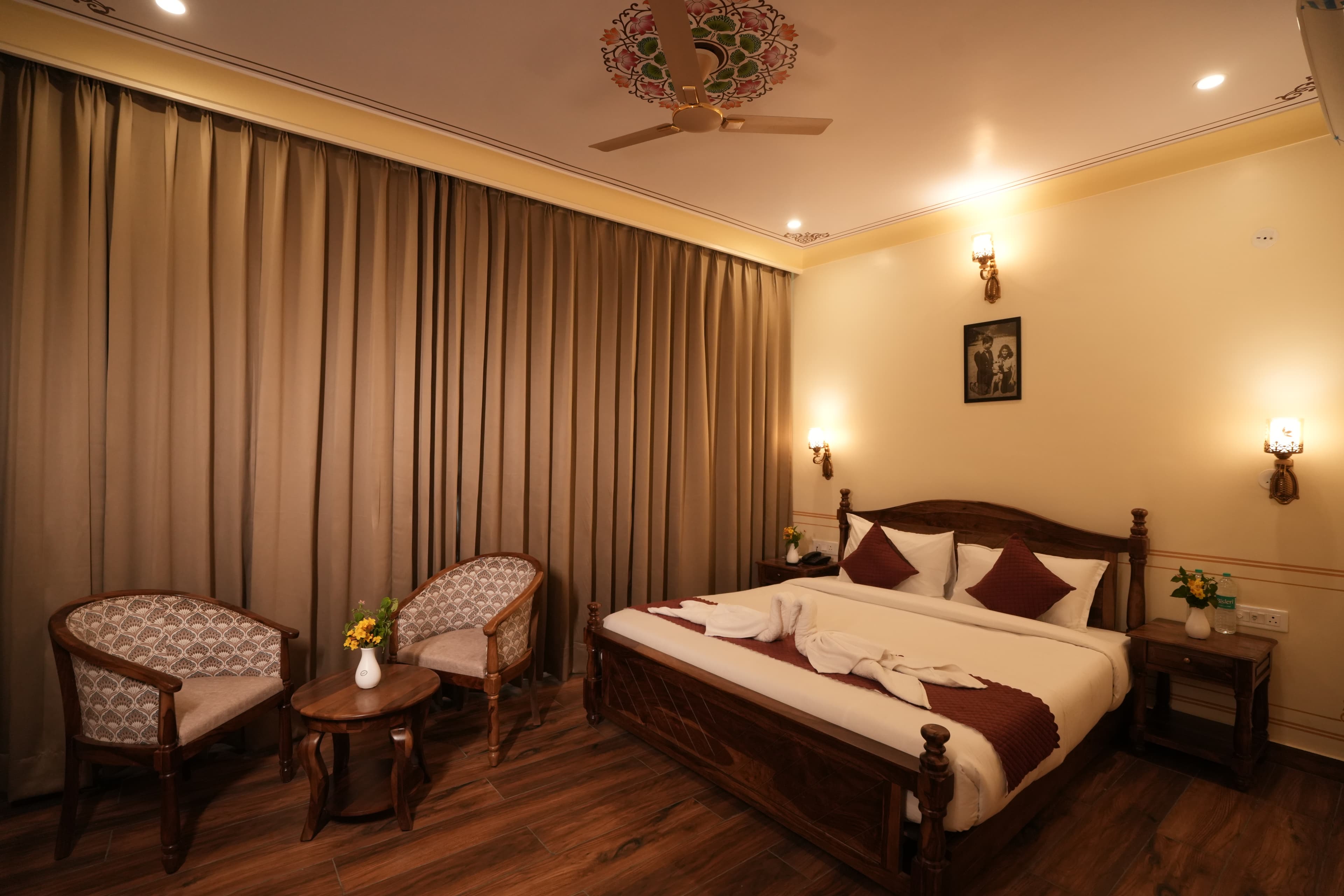 Royal Deluxe Room king bed with Rajasthani decor at The Ummed Haveli Jaipur