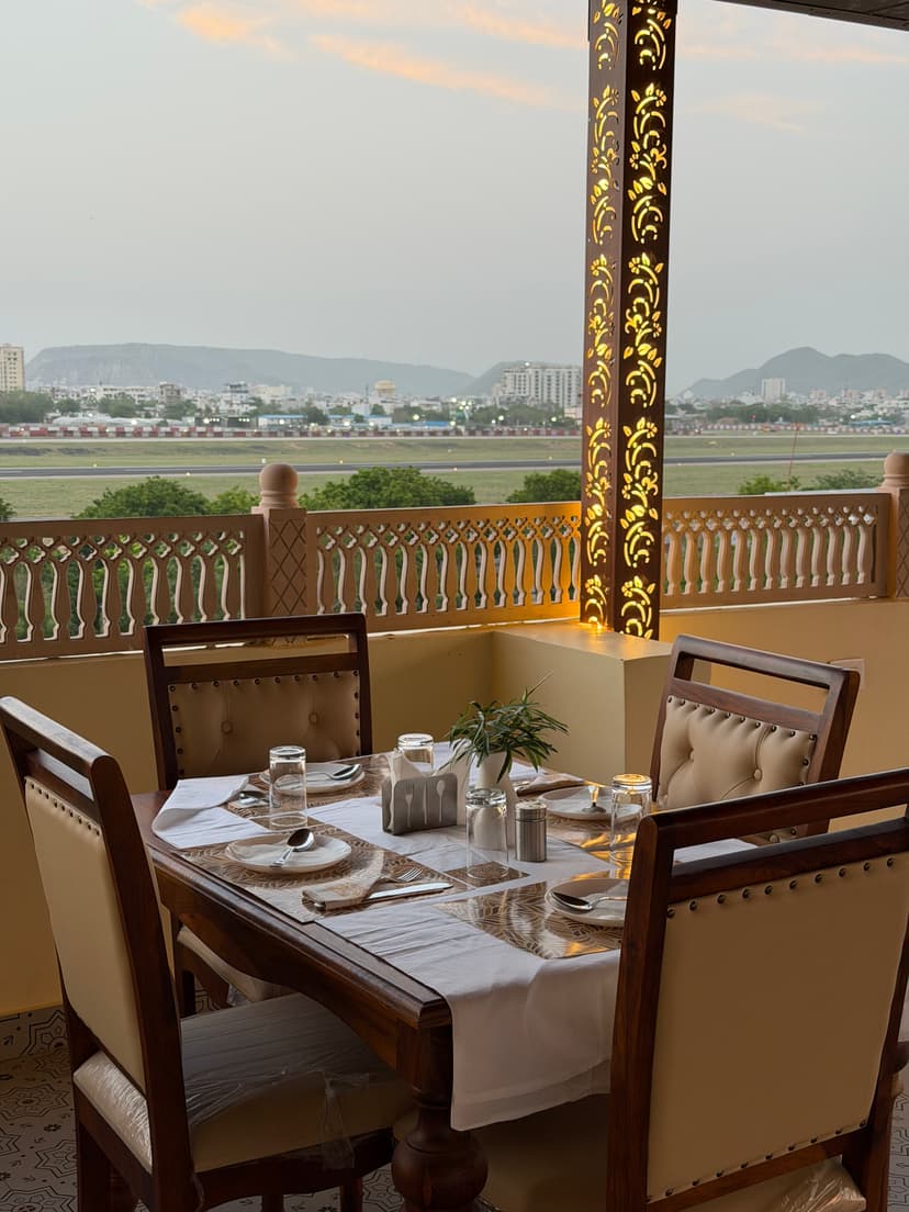 Candlelit Dinner table on rooftop with Airport view
